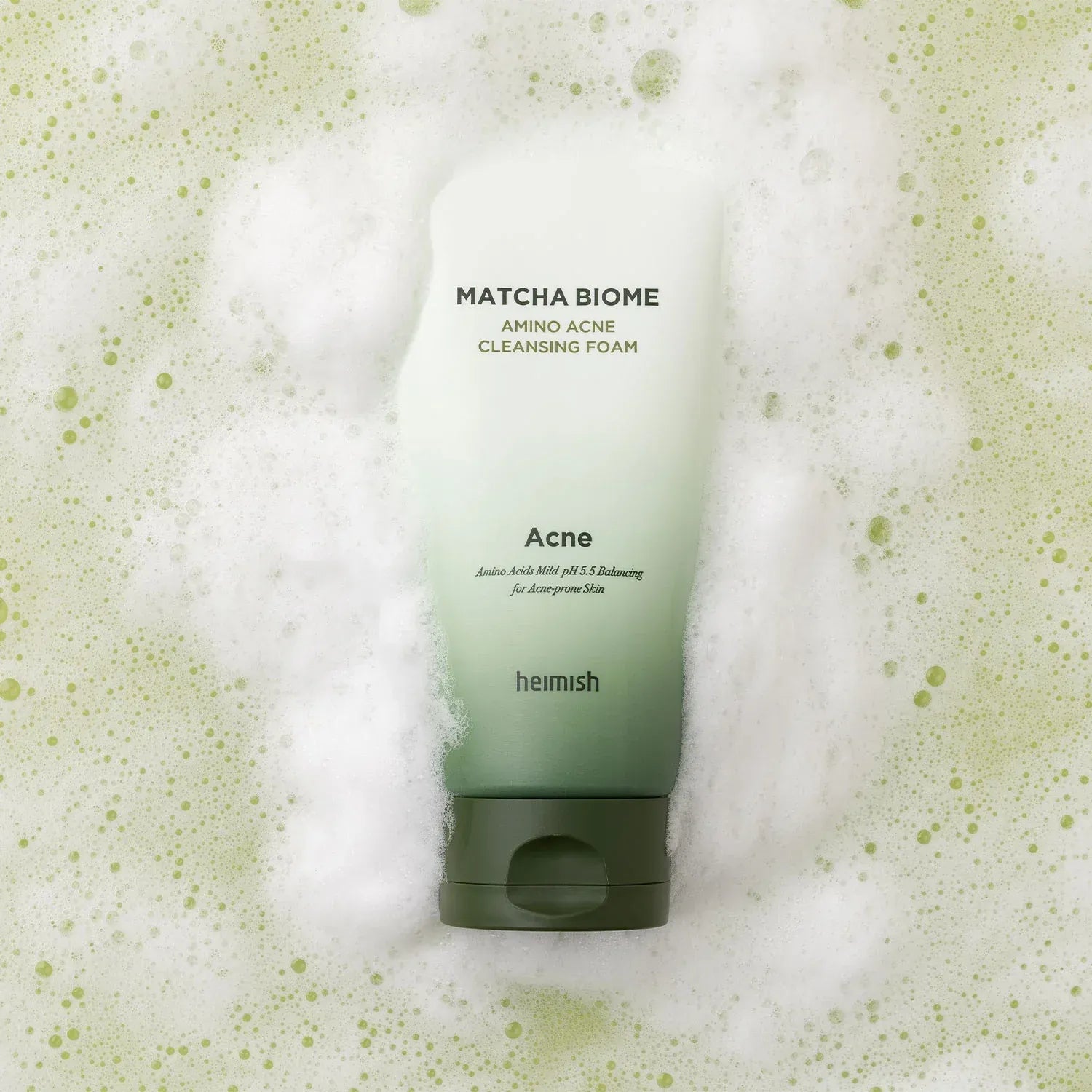 HEIMISH Matcha Biome Amino Acne Cleansing Foam 150g on bubbly green background