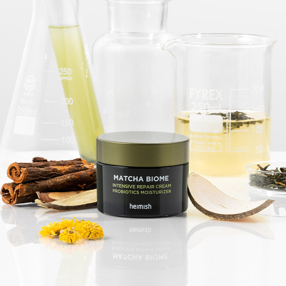 HEIMISH Matcha Biome Intensive Repair Cream 50ml surrounded by natural ingredients in a lab setting
