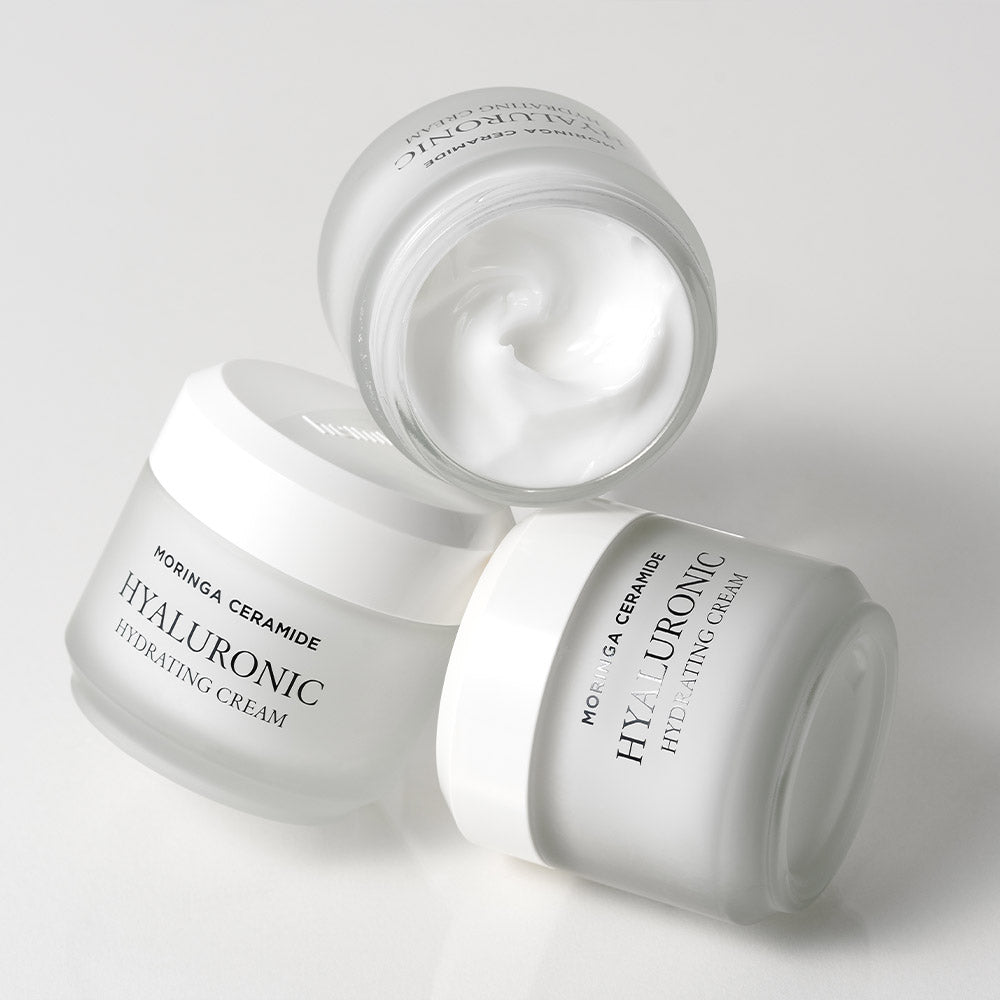 HEIMISH Moringa Ceramide Hyaluronic Hydrating Cream 50ml, three jars displayed on a white background with open lids showing cream texture