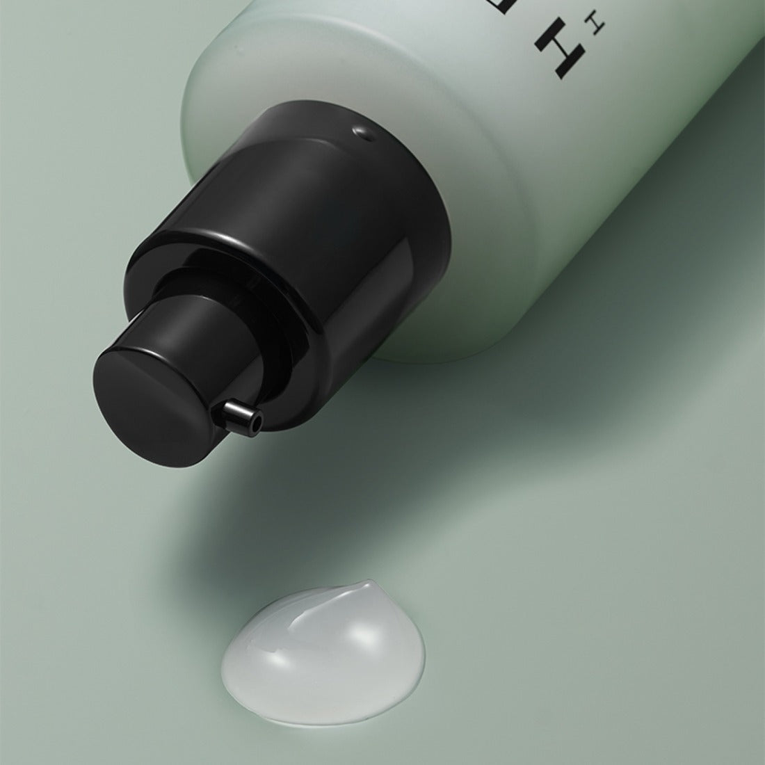 HERA Homme All-in-One Skin Hydro Treatment 150ml product image with dispenser and gel texture on a smooth surface