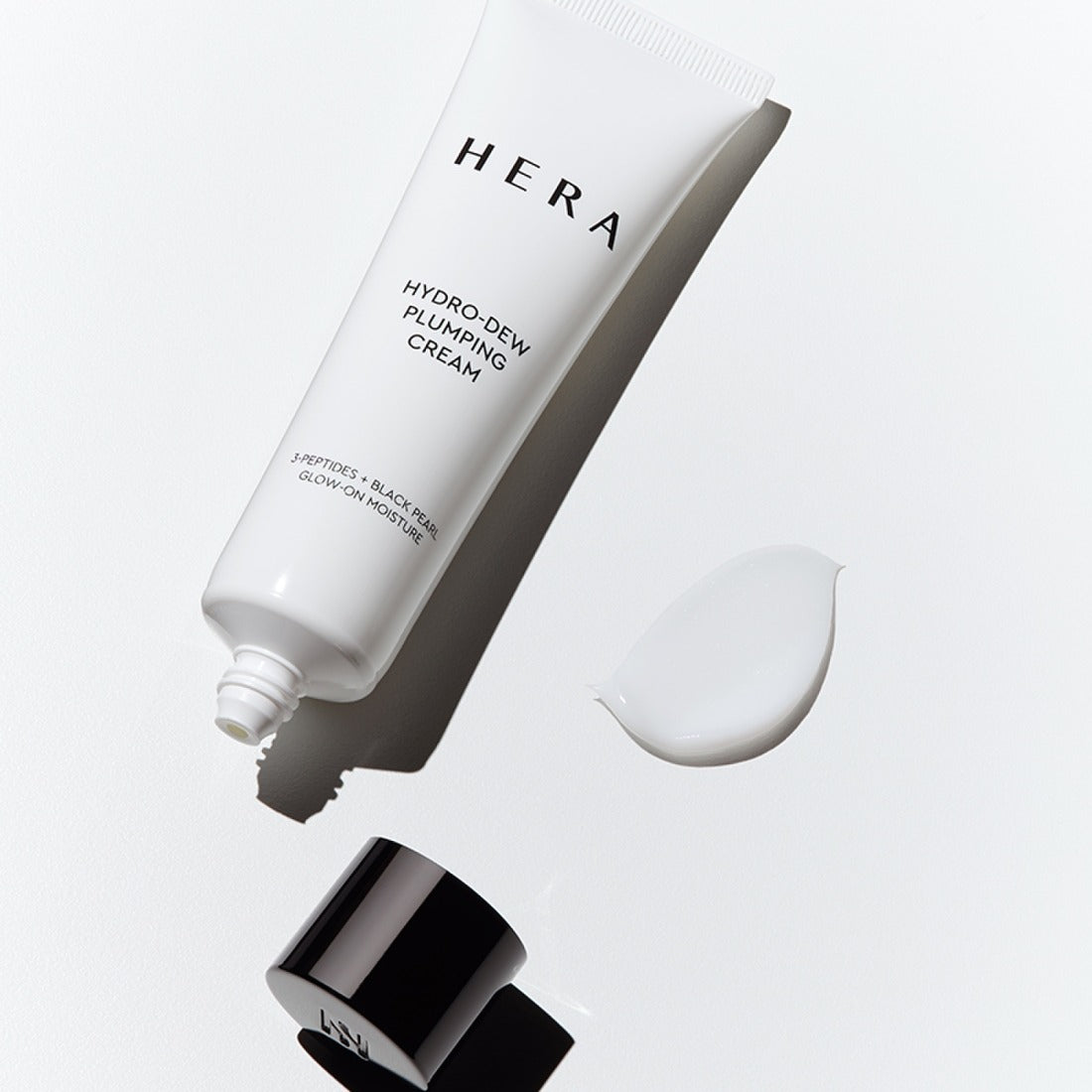 HERA Hydro-Dew Plumping Cream 50ml tube with cream texture on white background