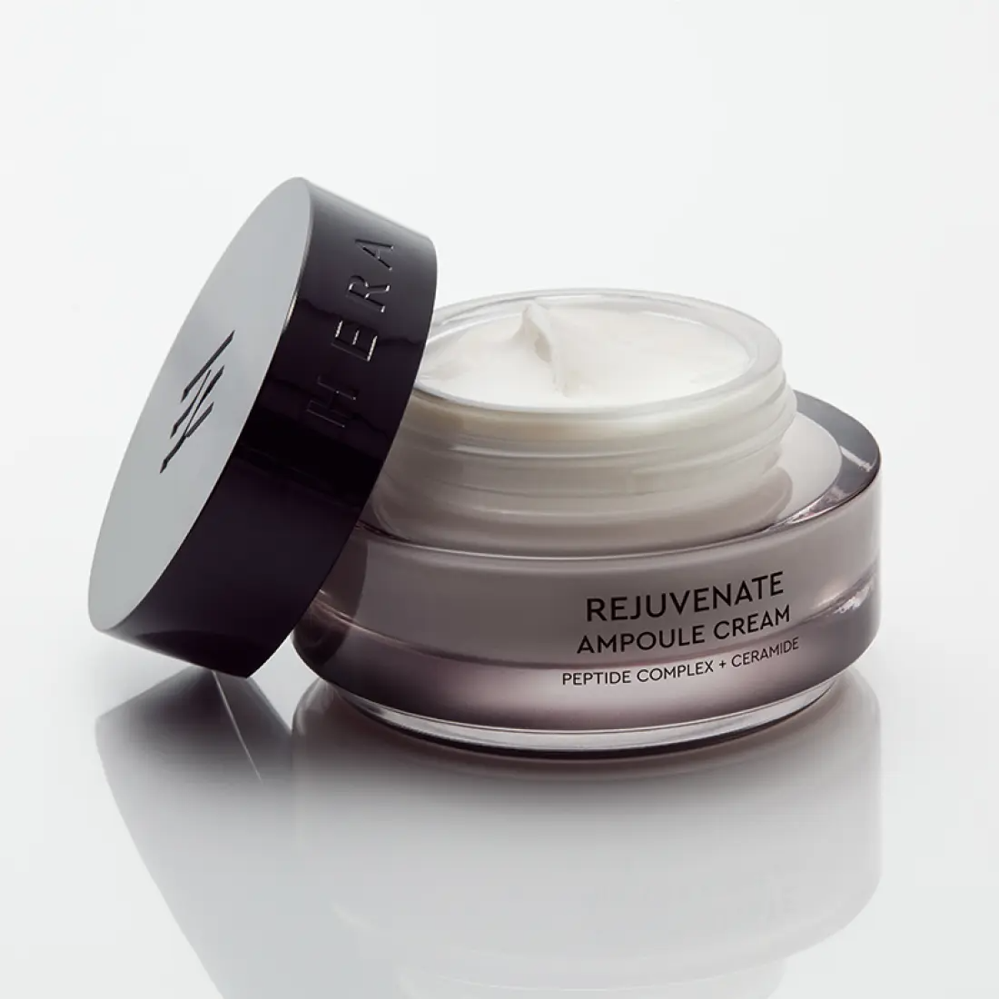 HERA Rejuvanate Ampoule Cream 50ml in an open jar showing creamy texture, enhancing youthful skin appearance with peptide complex and ceramide.