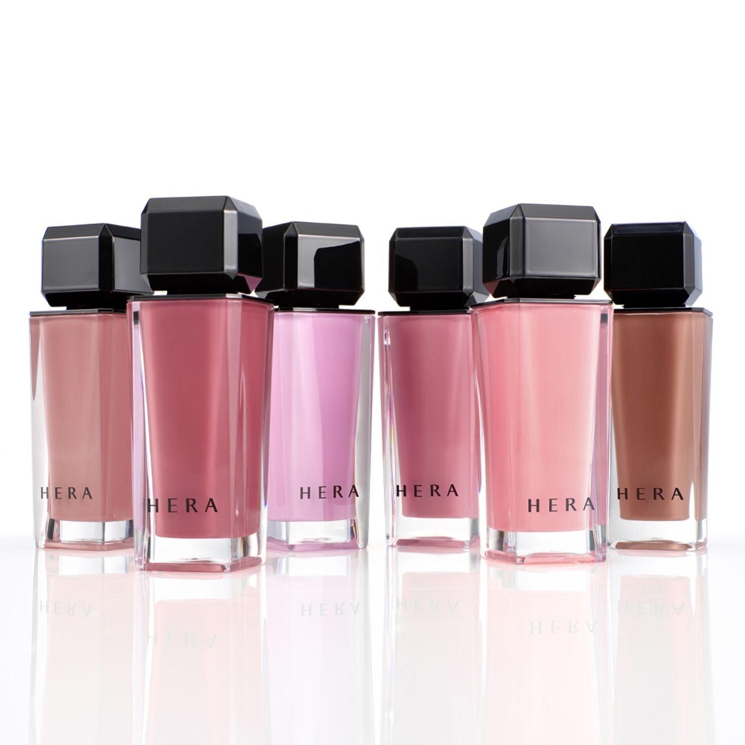 Collection of HERA Sensual Nude Gloss 5g bottles in various shades, showcasing elegant and luxurious lip gloss options.