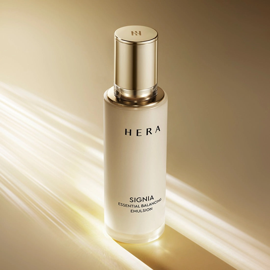 HERA Signa Essentail Balancing Emulsion 150ml bottle on a reflective surface with soft light highlighting the packaging elegance.