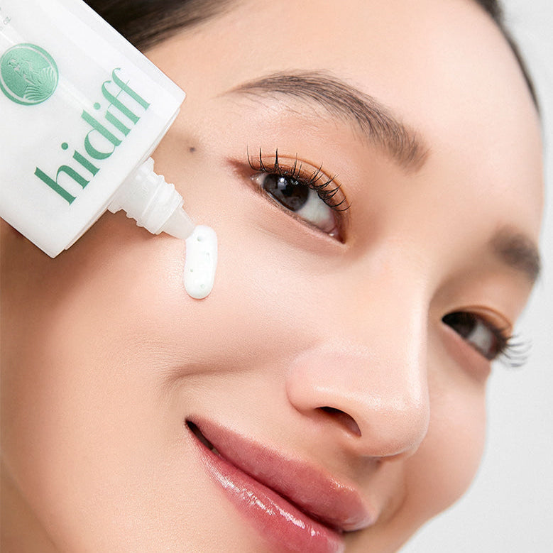 Woman applying HIDIFF Pure Tone Capsule Sunscreen on cheek for skin protection