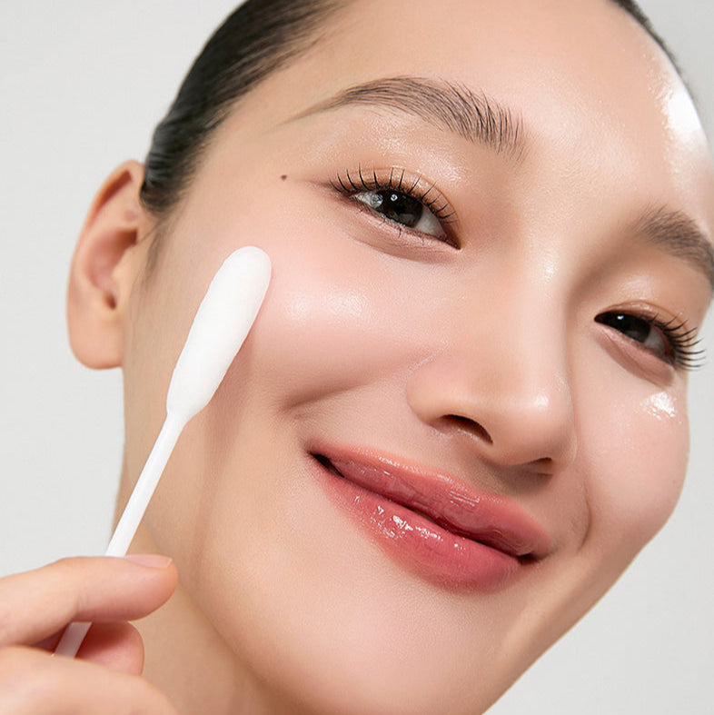 Woman smiling while using HIDIFF Royal Soft Clean Kit for skincare