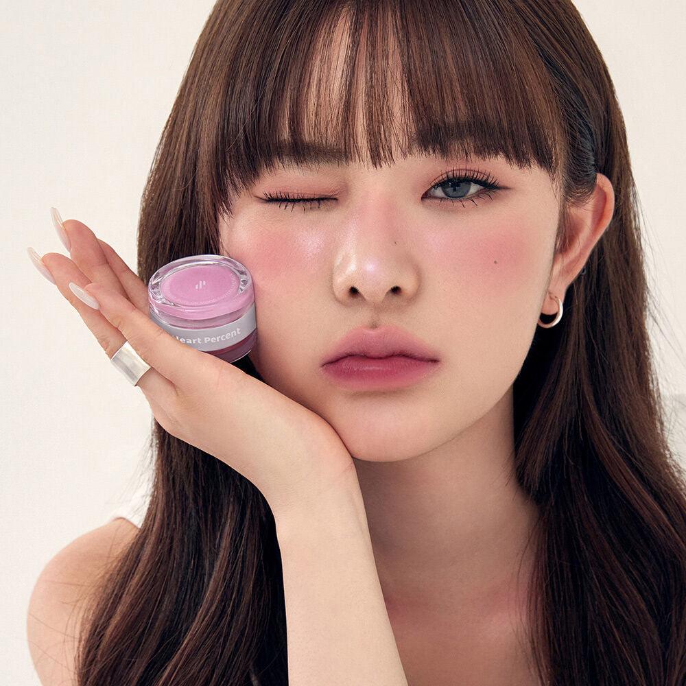Model with HEART PERCENT Dot On Mood Custom Lip & Cheek, showcasing pink tint for lips and cheeks.