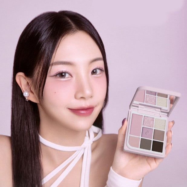 Young woman showcasing HEART PERCENT Dot On Mood Eye Palette with a variety of shades, perfect for versatile makeup looks.