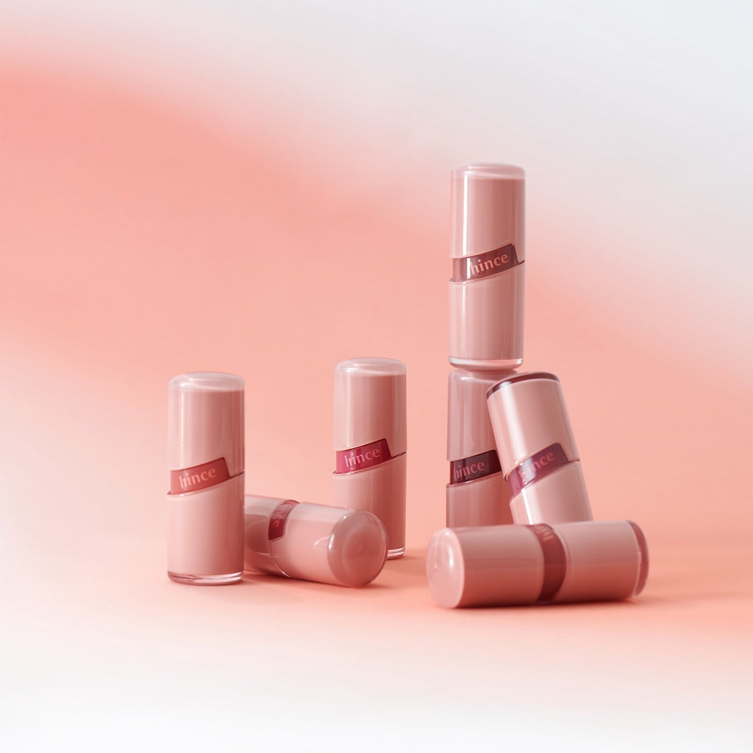 HINCE Ro Glow Gel Tint tubes on a soft pink and white background showcasing luxurious lip color.