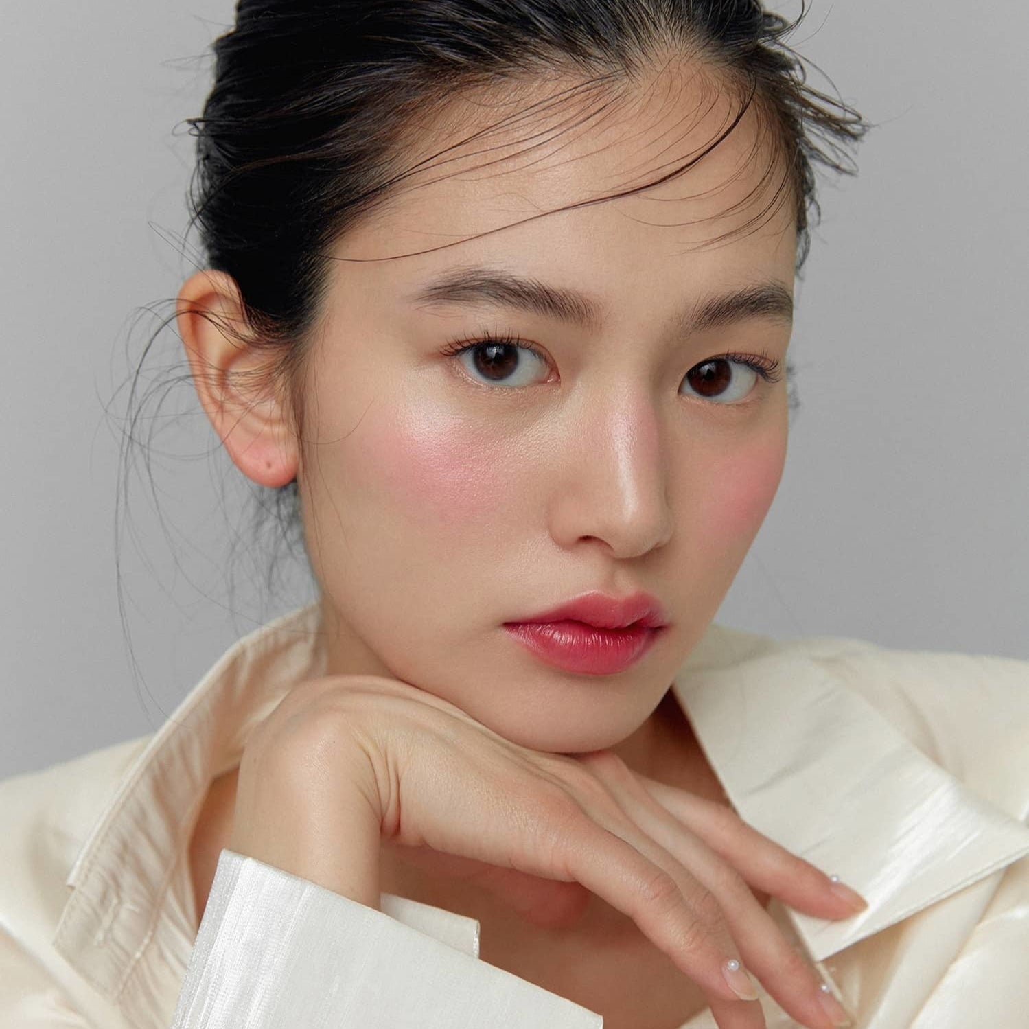 Model wearing HINCE True Dimension Glow Cheek in soft pink shade, showcasing natural glow and radiant skin.