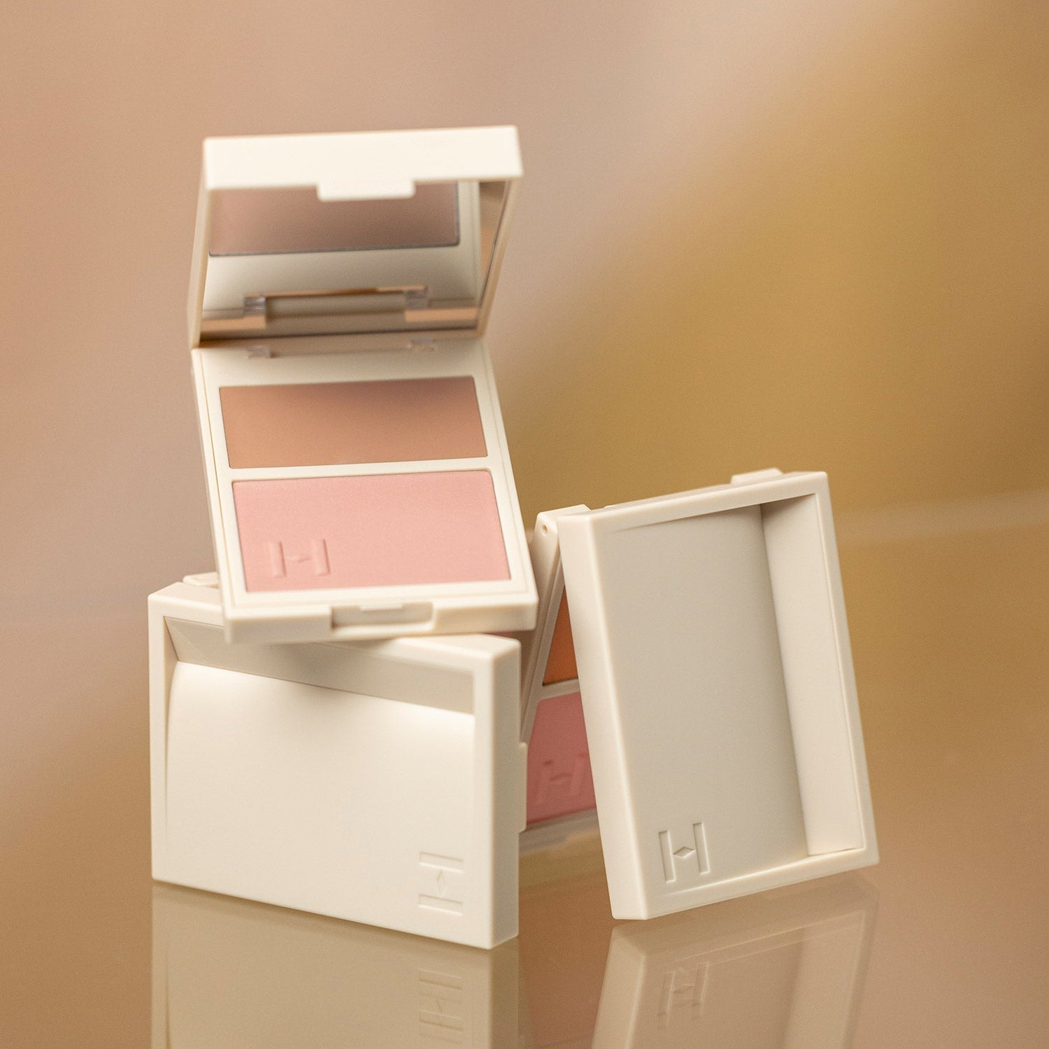 HINCE True Dimension Layering Cheek compact showcasing dual shades on a reflective surface.