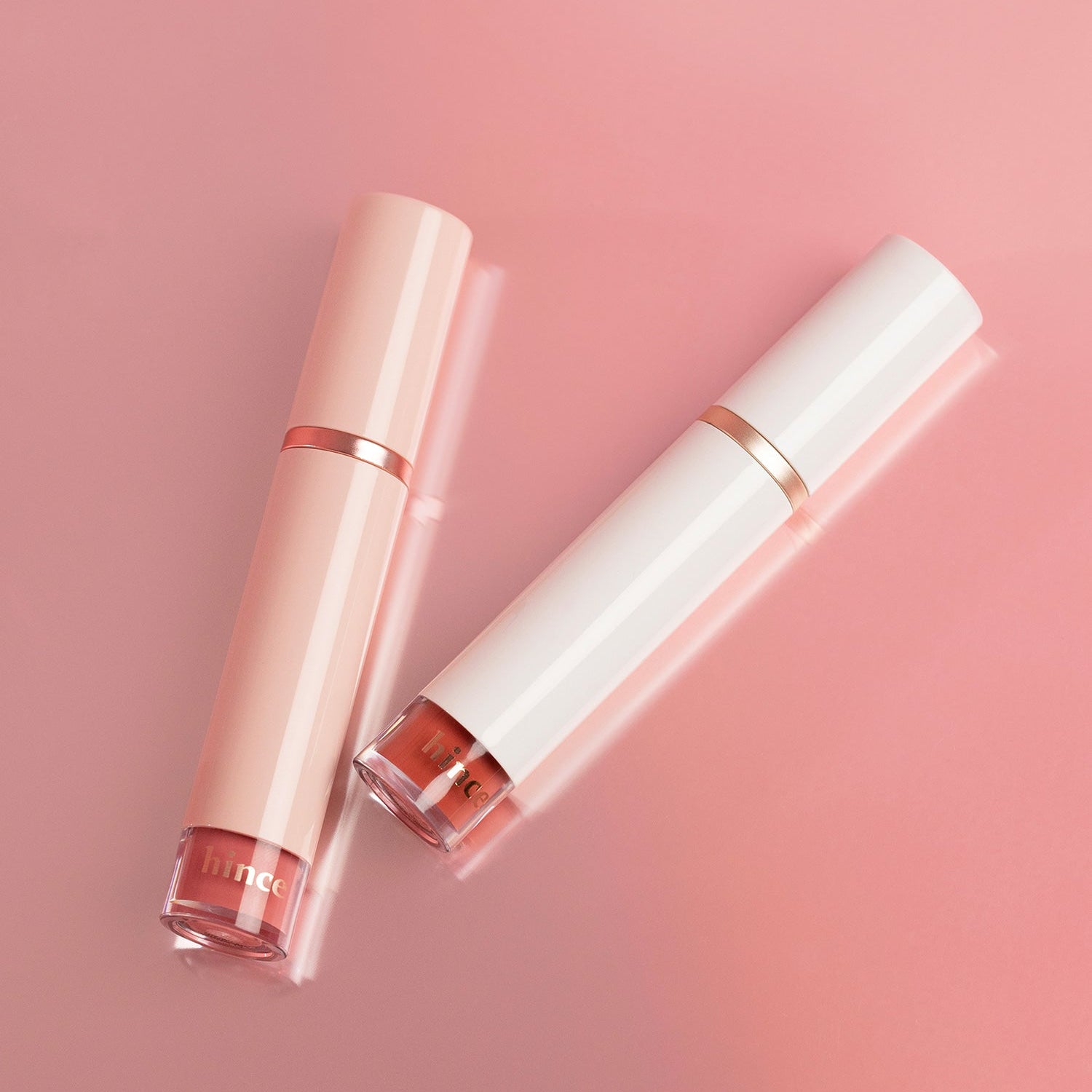 HINCE Mood Enhancer Water Liquid Glow in elegant pink and white packaging on a soft pink background, showcasing beauty and elegance.