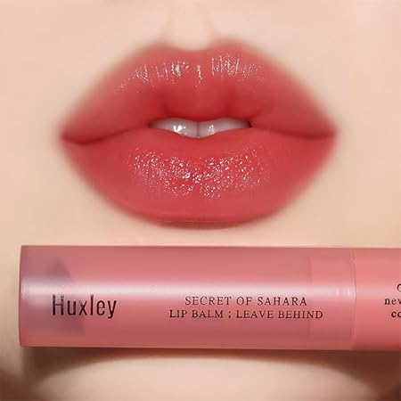 Close-up of lips with HUXLEY Lip Balm Leave Behide for luscious hydration.