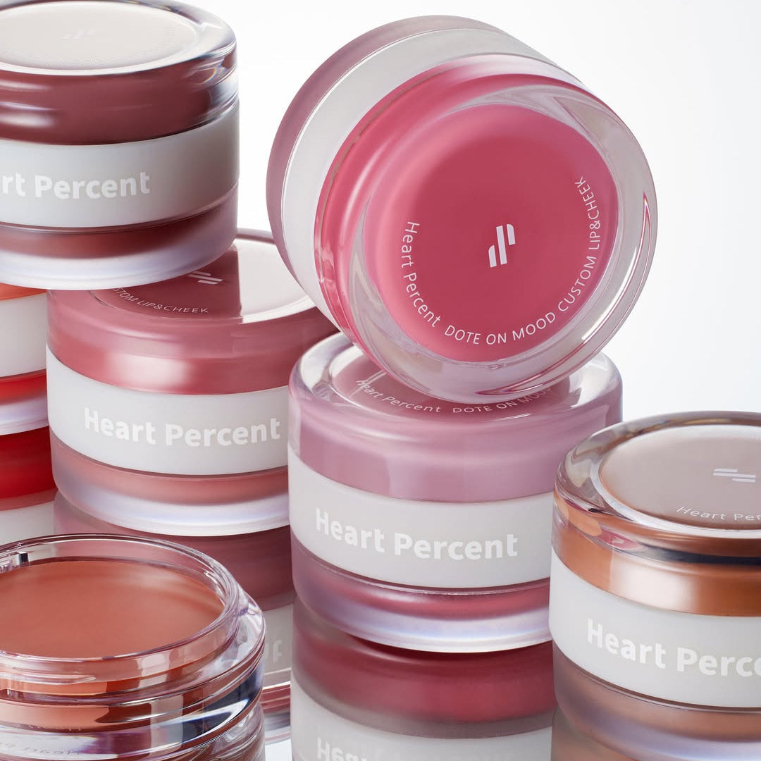 HEART PERCENT Dot On Mood Custom Lip & Cheek in various shades, showcasing vibrant color options for lips and cheeks.