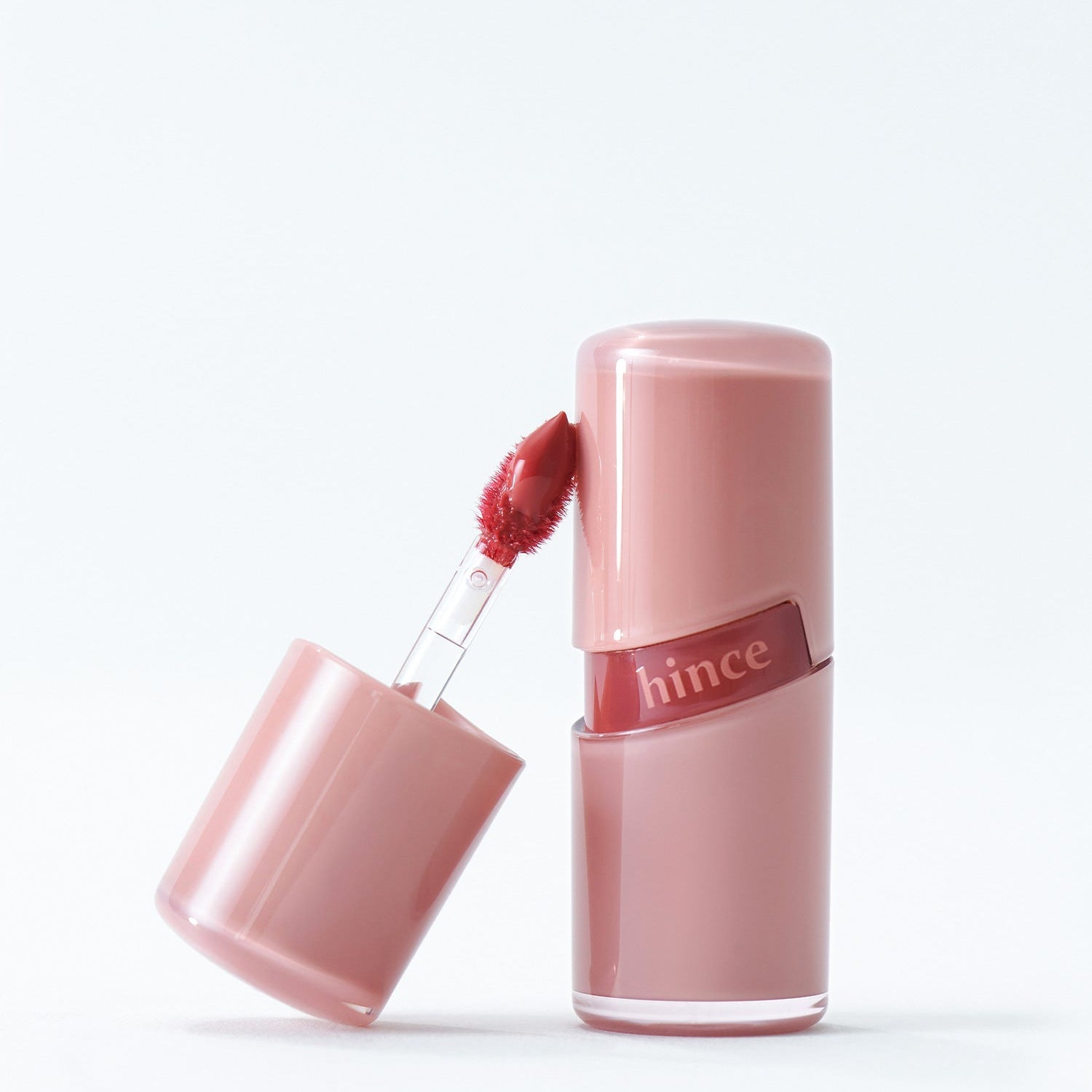 HINCE Ro Glow Gel Tint - Luxurious lip gel tint with radiant finish in pink bottle.