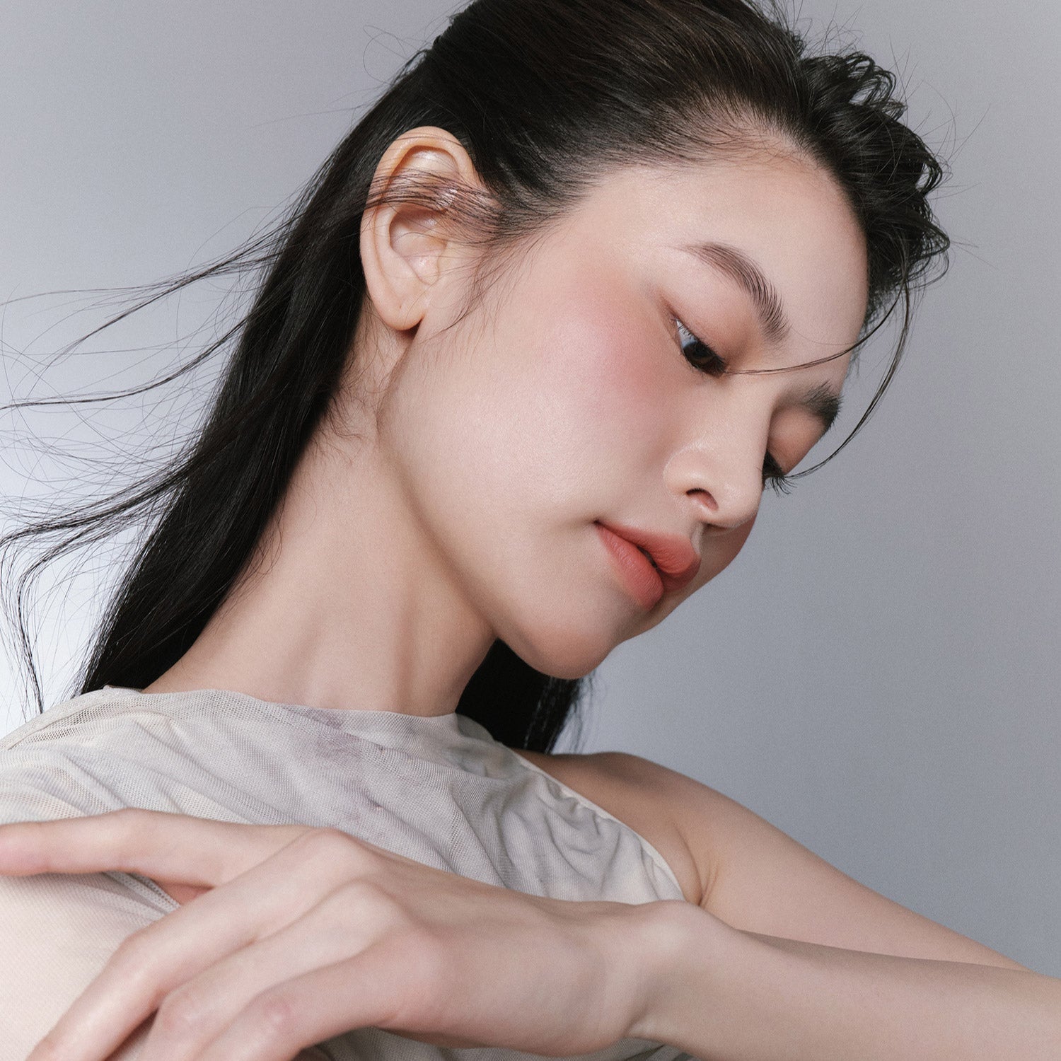 Woman using HINCE True Dimension Layering Cheek for a natural makeup look